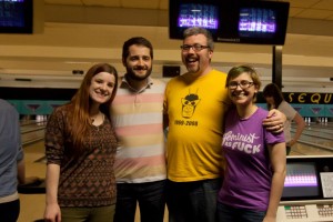 A group of four people, including the author and her husband, standing in front of bowling lanes at an abortion fundraiser.