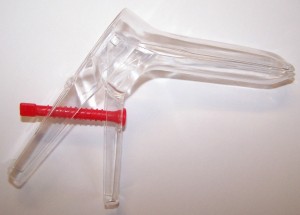 a plastic speculum with a red screw
