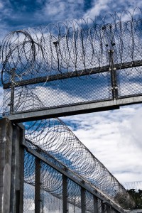 view of prison walls with barbed wire
