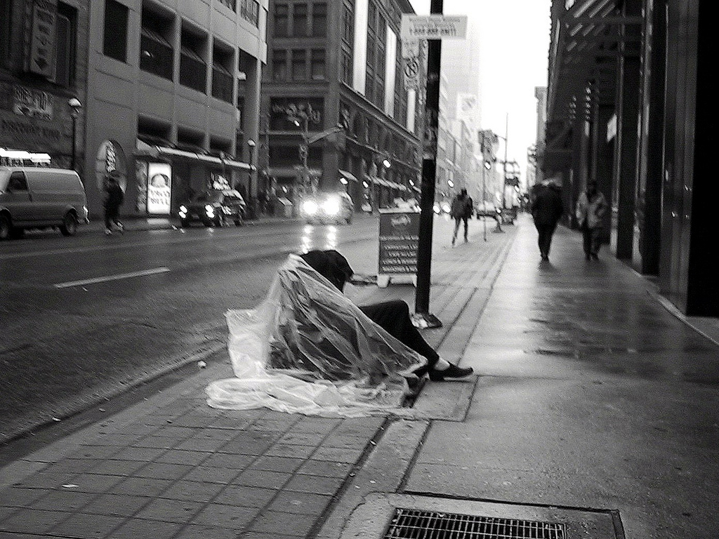 a homeless man sleeping on the streets