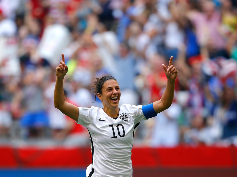 Carli Lloyd raises her fingers in the air after her third World Cup goal