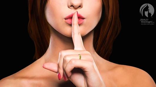 Ashley Madison logo depicts white woman with finger over lips in "shhh" gesture