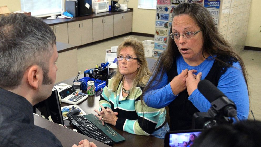 Kim Davis, with another woman, scowling at a man trying to get a marriage license