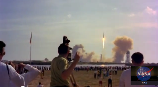 Man standing in front of mid-century shuttle launch