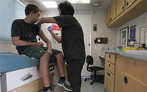 Teen being vaccinated